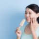 woman with sensitive teeth eating a popsicle